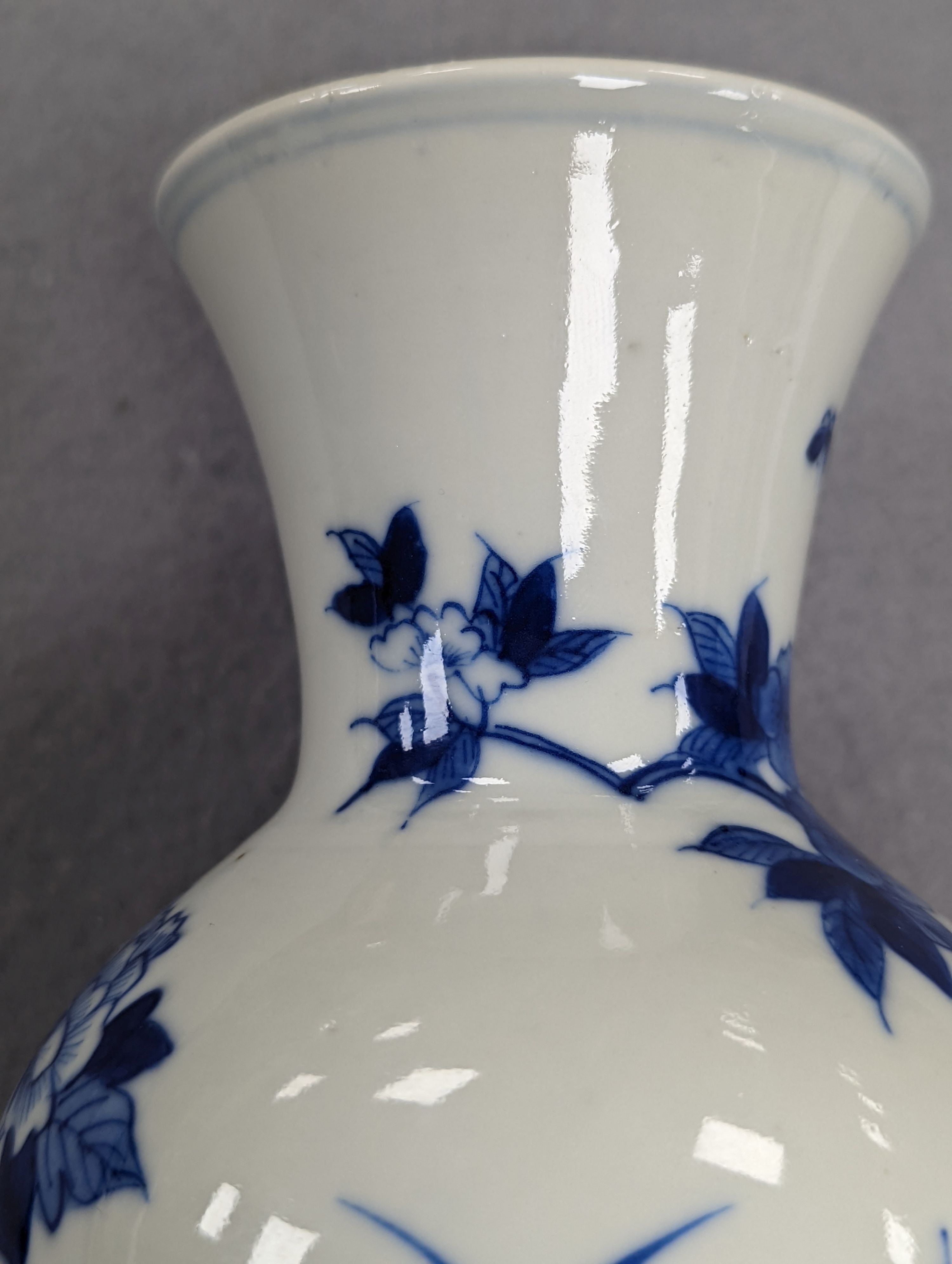 A late 19th century Chinese blue and white baluster vase, painted with birds amid flowers and rock work, pseudo Kangxi mark. 26cm